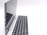 a white laptop with a black keyboard on a white surface