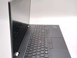 a black laptop with a red button on the keyboard