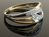 a close up of a gold and silver ring on a black surface