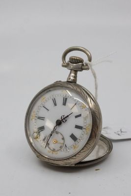 a silver pocket watch with roman numerals on it