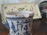 a blue and white cup sitting on a wooden table