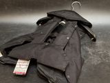 a black jacket on a hanger on a metal surface