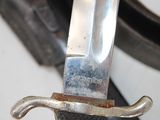 a close up of a knife with a handle on it