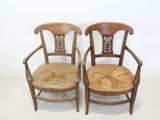 pair of antique wooden chairs with wicker seat and back