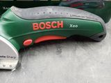 a close up of a green and red electric tool on a table