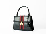 a black and red handbag with a gold lock on it