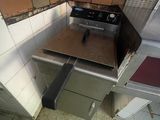 a stove in the corner of a kitchen with tile on the floor