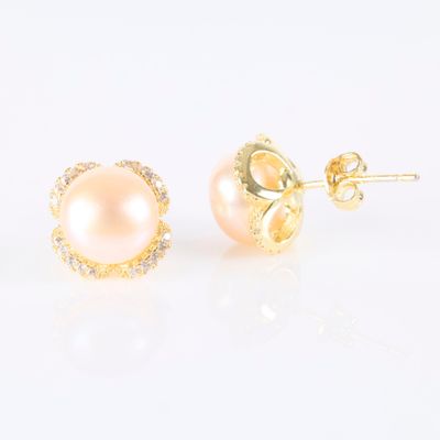 a pair of pearl and diamond stud earrings