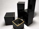 three black boxes with gold trims on a white background