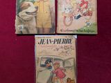 trois livres pour enfants sont posés sur une surface rouge