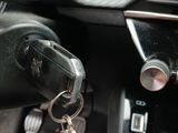 a car dashboard with a car key and a car keychain hanging from it