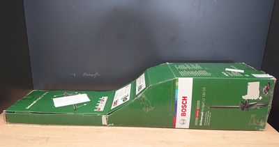 a green guitar case sitting on top of a wooden table