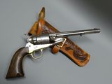 an old revolver with a leather case on a gray surface