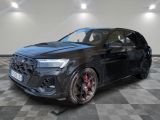 a black audi suv parked on a checkered floor in a showroom
