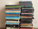 books stacked on top of each other on a wooden floor