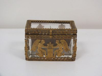 brass and glass box with angels and angels on it on a white surface