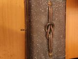 a suitcase sitting on top of a shelf next to a wooden cabinet