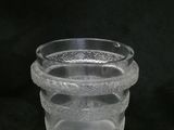 a clear glass vase with a snake design on it