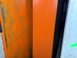 an orange door in the corner of a room