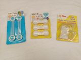three plastic toothbrushes and a pair of scissors on a white surface