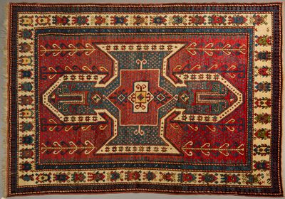 a red and blue rug with a design on it