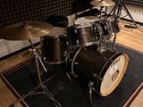 a drum set up in a recording studio with a microphone