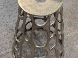 a metal stool with a hole in the middle of it