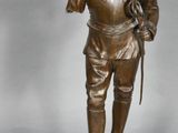 bronze figurine of a man with a dog on a pedestal