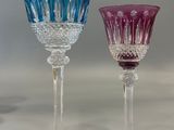 three wine glasses sitting next to each other on a table
