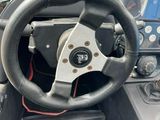 a steering wheel in the driver ' s seat of a vehicle