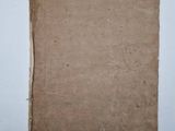 an old book sitting on top of a table next to a white wall