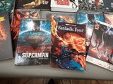 a lot of comic books sitting on a table