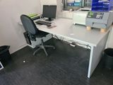 a desk with a computer and a printer on it
