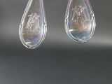 two spoons that are hanging from a wire