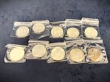a bunch of gold coins in plastic bags sitting on a table