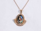 a close up of a necklace with a picture of a woman on it