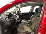 the interior of a red car with a steering wheel and dashboard