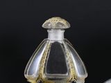two perfume bottles sitting next to each other on a table