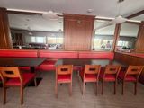 a table and chairs in a restaurant with a mirror on the wall
