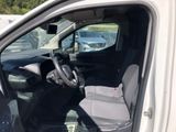 the interior of a white van with a grey seat and steering wheel