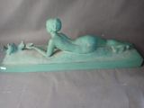 a statue of a woman laying down on a pillow