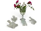 a glass vase with flowers in it and birds in the vase