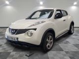 a picture of a white nissan juke suv parked in a garage