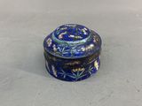 a close up of a small blue box with flowers on it