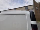 a white van that is parked in front of a building