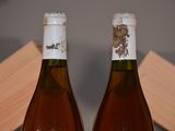 two bottles of wine sitting next to each other on a table