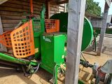 a green machine that is sitting in the dirt