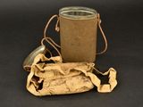 a brown bag and a metal container on a black surface