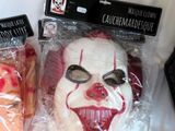 two masks that are wrapped in plastic and sitting on a table