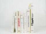 a lot of books that are stacked on top of each other
